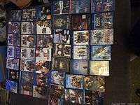 Display of multiple Blu-ray and DVD movie cases laid out in rows, showing titles: The Wild Brothers, Free Fire, Evidence, Jason Bourne, Insideous 3, The Purge Election Year, Las Vegas, The Bay, Zootopia, and more.