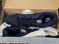 Pair of navy blue K-Swiss men's sneakers in original box with tissue paper inside.