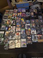 Wide shot of multiple game cases arranged on a surface.