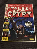 Full cover view of the Tales from the Crypt comic book showing detailed artwork and signatures.