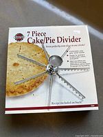 Photo of the Norpro 7 Piece Cake/Pie Divider box showing front of packaging and product image with description.