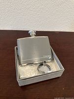 Front view of British Airways Concorde lamb leather and stainless steel hip flask with screw cap and funnel in original box, showing Concorde logo on leather.