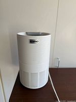 Front view of a white Renpho air purifier with textured cylindrical body and logo on the front.