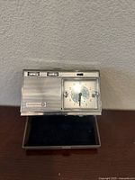 Front view of the vintage Westinghouse travel clock radio showing the analog clock face, tuning and volume knobs, and speaker grille.