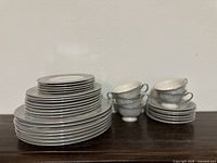 Stack of vintage Castleton China dinner plates, cups and saucers shown in one image