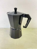 Front view of black aluminum 6 cup stovetop espresso maker with Primula branding and angled octagonal design.