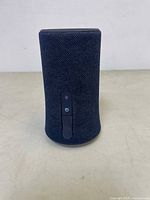 Front view of black cylindrical Anker Soundcore Flare Mini speaker with fabric mesh and control buttons