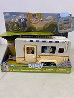 Full view of Bluey Caravan Adventures toy in box showing caravan and collectible figure.