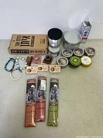 Full view of candles, incense sticks, bracelets, and stones arranged on table