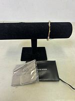 Front view of Caroline Neron bracelet on black bracelet display stand showing bead detail, dust bag and cleaning cloths included.