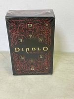 Front view of sealed black and red Diablo The Sanctuary tarot card deck box showing intricate design and symbols.