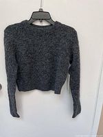 Front view of dark gray fuzzy textured alpaca wool-blend sweater with long sleeves and crew neck, size small.