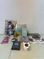 Overview of all items in lot including bags, kits, gloves, clothing, and electronic accessories.