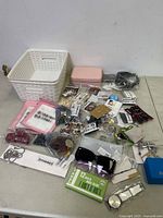 Overview of all jewelry and accessory items including bracelets, earrings, sunglasses, and cases spread out on a table.