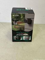 Front of WYZE Cam v4 retail box showing camera mounted outdoors with text highlighting night color vision and built-in spotlight.