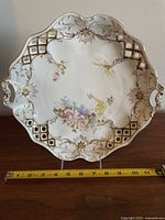 Top view of the 12-inch Carl Tielsch porcelain serving platter showing floral design, reticulated edges with gold accents, and integrated handles.