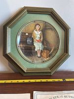 Full view of framed decorative plate with octagonal wooden frame, signed and dated 1985.