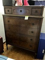 Full view of antique wooden dresser showing all seven drawers and overall design