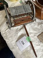 Angle showing right side and top of limber with attached wheels, wood slats, and metal storage box lid closed