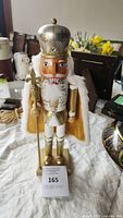 Front view of the nutcracker figure standing upright showing detailed crown, face, and outfit.