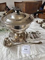 Full set displayed on table with fondue pot, ladle and fondue forks.