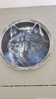 Front view of the collector's plate showing detailed wolf illustration with decorative border.