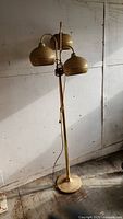 Full view of the vintage gold floor lamp with three rounded light fixtures showing overall condition and structure.