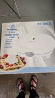 Photo of the box showing front label of Westinghouse WST3010ZE 2 slice Belgian waffle maker with features listed.