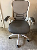 Front view of gray mesh office chair showing mesh backrest, seat, white frame, armrests, and caster wheels.
