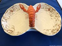 Top view of the porcelain lobster divided serving dish showing the two divided sections and the raised lobster figure in the middle.