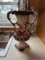 Front and side view of the Capodimonte porcelain vase showing detailed floral decorations and shape