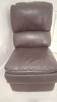 Front view of black padded leather chair showing cushioned seat and backrest in good condition
