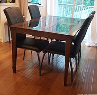 Side view of dining table and four chairs in room setting