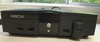 Front view of the original Xbox showing four controller ports, power and eject buttons