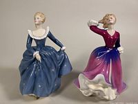 Front view of both porcelain figurines showing detailed painting and facial features