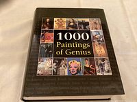 Front cover of the hardcover book showing the title with a collage of famous paintings.