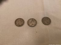 Obverse side of three Canadian silver quarters featuring King George VI, showing the portrait and dates 1941, 1943, and 1950.
