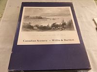 Blue slipcase with black and white illustration of Canadian coastal scene including ships and landscape, titled Canadian Scenery Willis & Bartlett.