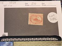 Photo of the 1859 Canadian 5 cent beaver postage stamp on a black background card with catalog information and pricing.