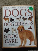 Front cover showing title and images of different dog breeds, including a Golden Retriever prominently.