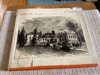Image of the front cover of the book showing the title, author, and illustration of Rideau Hall. The dust jacket is worn and torn but intact.