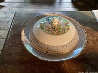 Top view of Royal Albert Silver Birch muffin dish covered with its lid, showing floral and tree design with metallic trim.