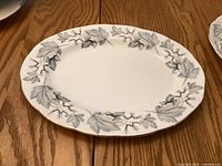 Top view of the oval platter showing silver maple leaf pattern and gold rim