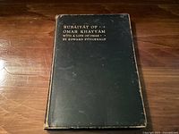 Front cover of the book Rubaiyat of Omar Khayyam showing title and author details in gold embossing on a dark hardcover.