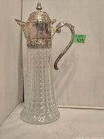 Front view of the vintage jug showing the textured glass body and silver plated top and handle.