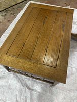 Top view of solid wood coffee table showing planked top with medium brown finish and visible wood grain.