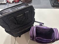 Joan & David black quilted backpack and La Vie Vert purple makeup bag side by side, showing overall size and style.