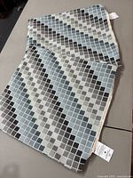 Two folded Westex pillow covers laid on flat surface showing the checkered pattern and tags