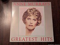 Front cover of Anne Murray's Greatest Hits vinyl album, showing a portrait of Anne Murray with the title in red text.