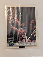 Front of Alonzo Mourning basketball rookie promo card showing dunk action, Classic logo, and 92 Draft Picks label.